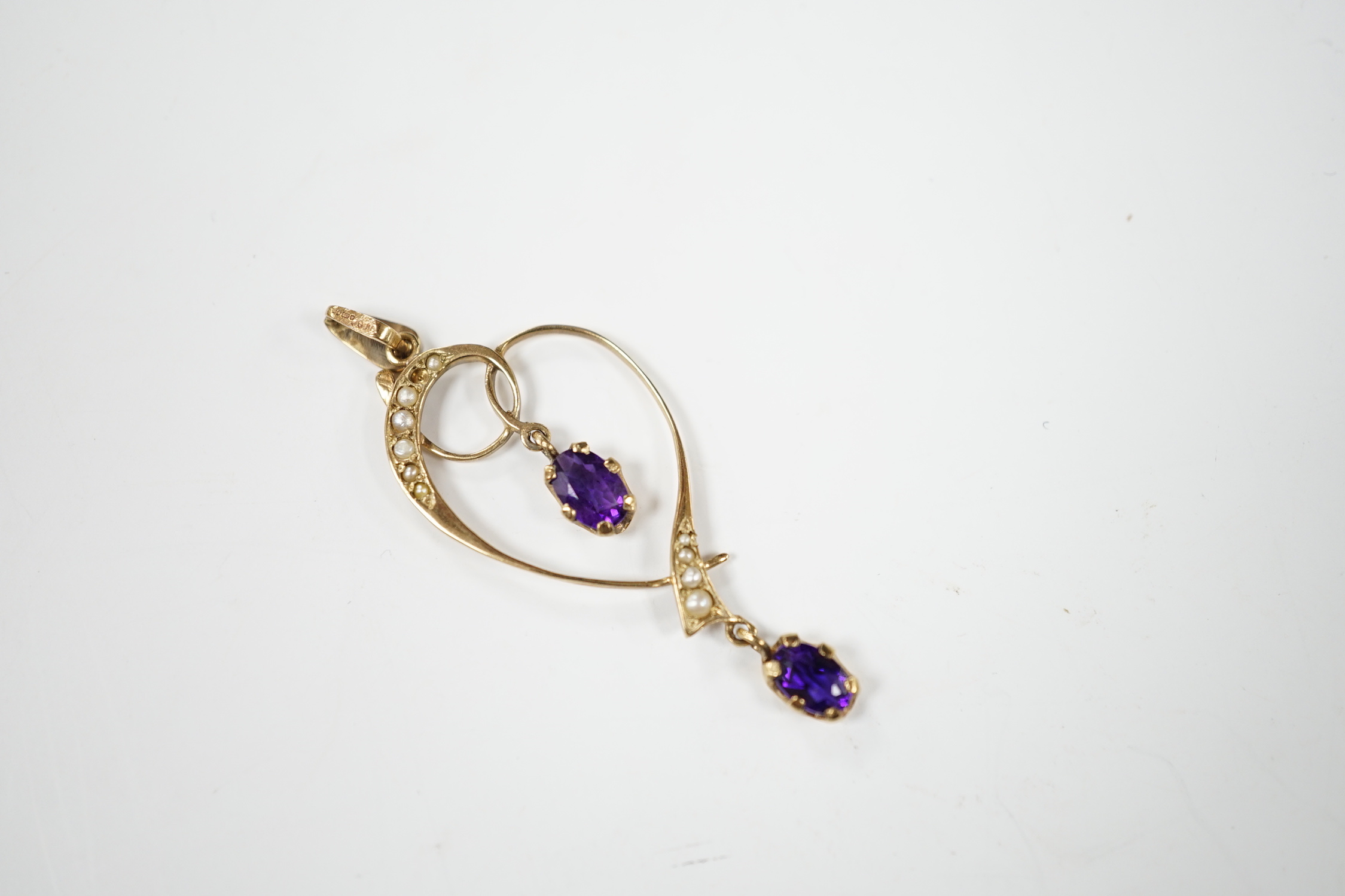 A modern Edwardian style 9ct gold, amethyst and seed pearl set drop pendant, 45mm, gross weight 1.6 grams.